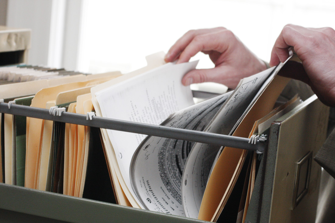 Hands going through files